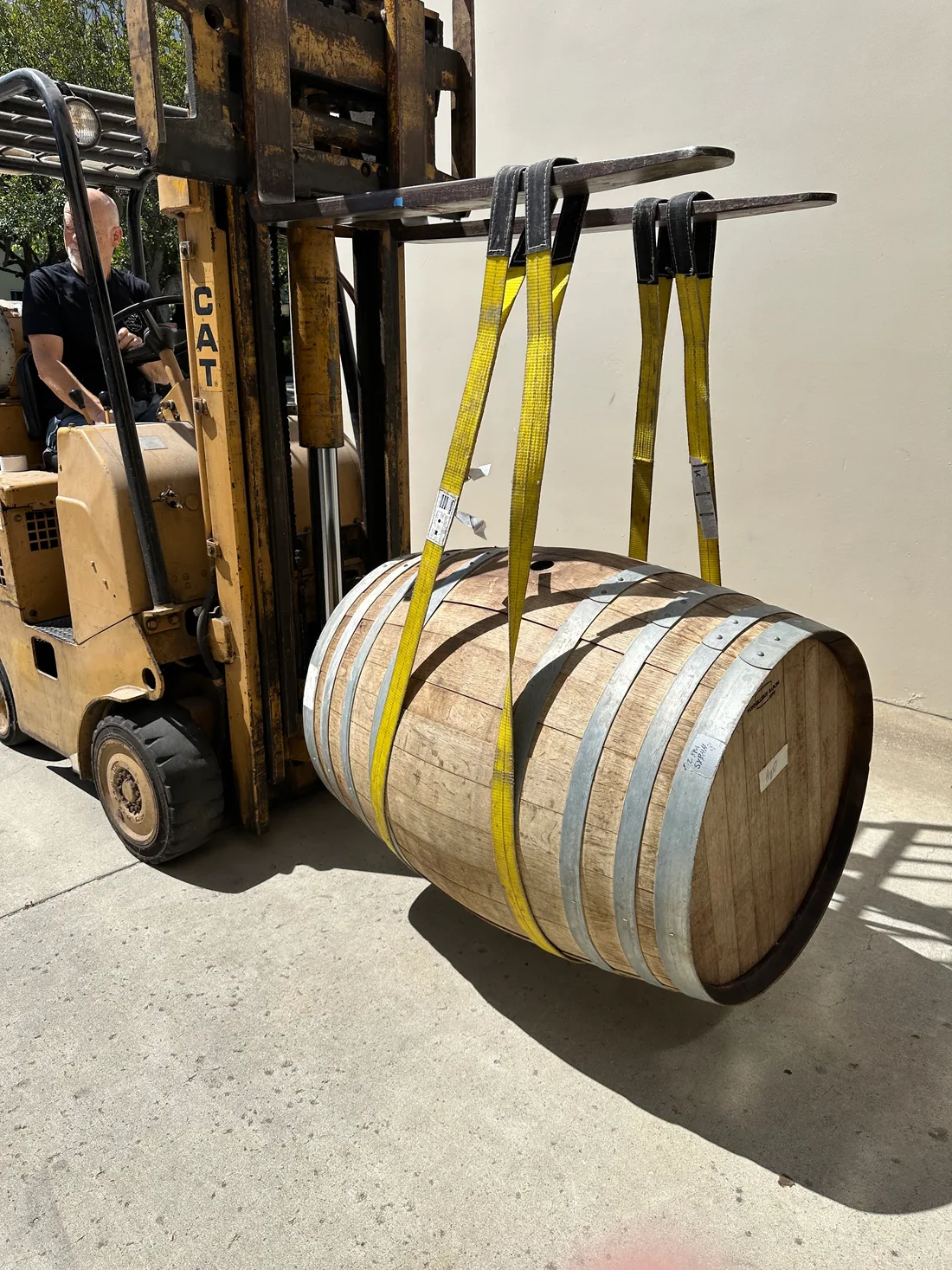 An oak barrel being moved by forklift